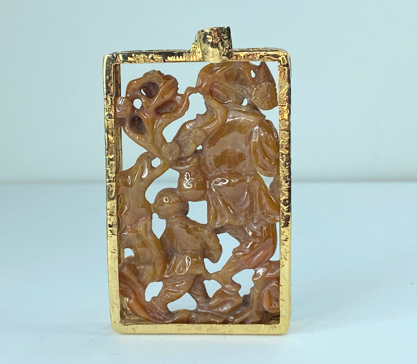 Custom orange jadeite carving wiseman with boy cradling a fish