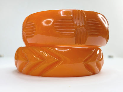 Pair of marbled orange and butterscotch deep carved Bakelite bangles 64.7g GS183