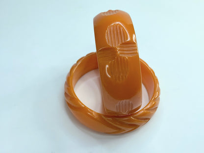 Pair of marbled orange and butterscotch deep carved Bakelite bangles 64.7g GS183