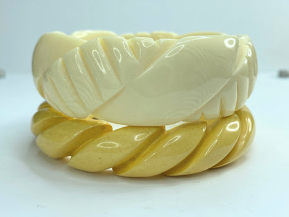 Pair of carved celluloid faux ivory and Honey Bakelite bangles GS184