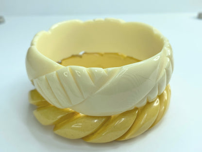 Pair of carved celluloid faux ivory and Honey Bakelite bangles GS184