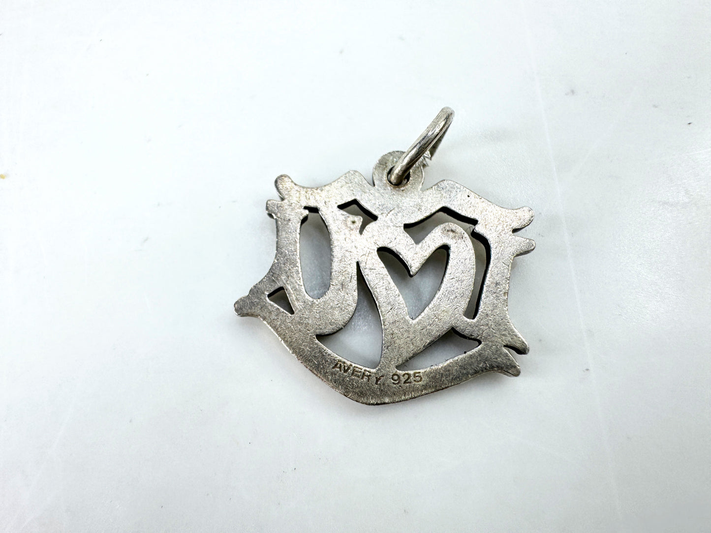 JR1923 - James Avery sterling silver “I Love You” charm pendant with open heart center design. Marked AVERY 925; approx. 19 x 17mm; 2.1g.